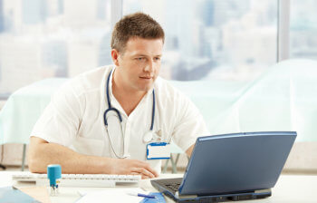 healthcare professional using a laptop